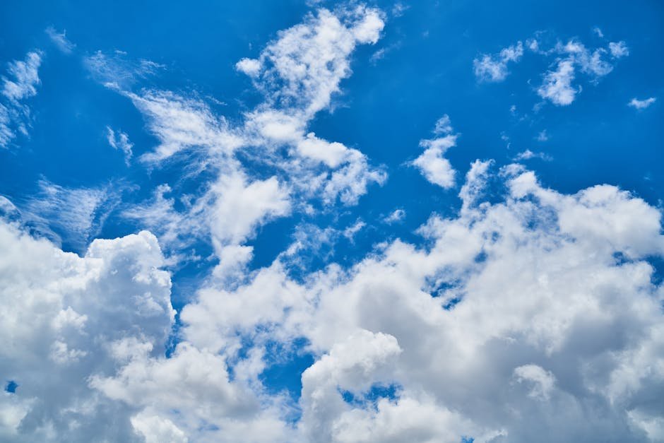 Vibrant cumulus clouds scattered across a clear blue sky, highlighting a perfect day.